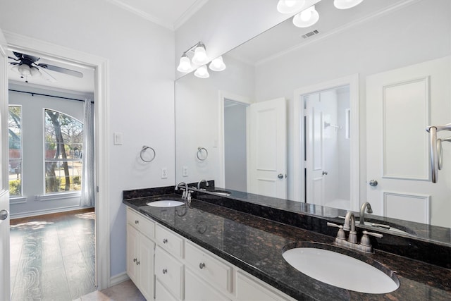 bathroom with hardwood / wood-style flooring, ceiling fan, crown molding, and vanity