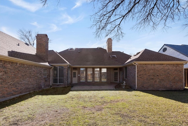 back of property with a lawn and a patio area