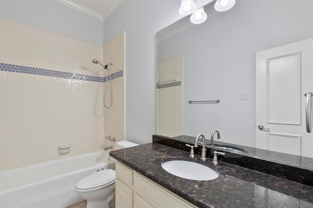 full bathroom with ornamental molding, toilet, vanity, and tiled shower / bath