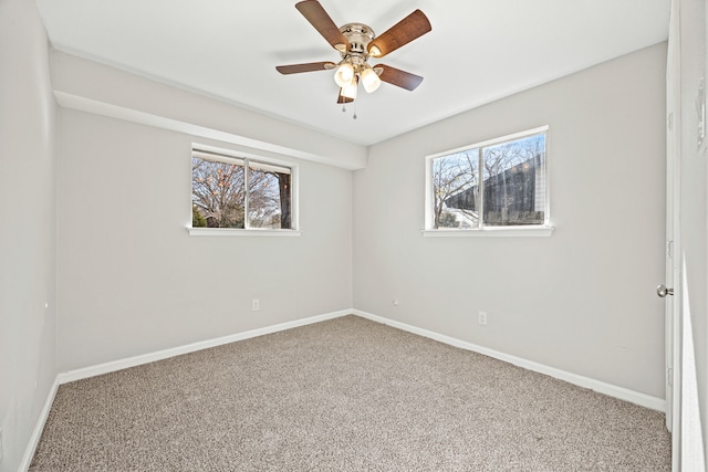 carpeted spare room with ceiling fan