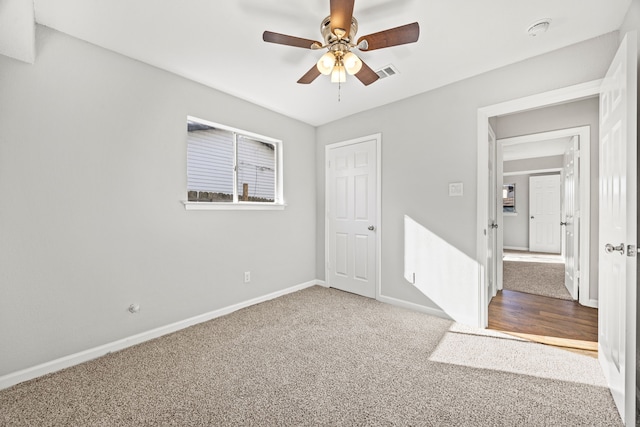 unfurnished bedroom with carpet, a closet, and ceiling fan