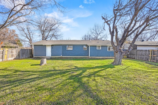 rear view of house featuring a yard