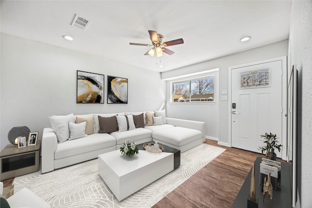 living room featuring hardwood / wood-style flooring and ceiling fan