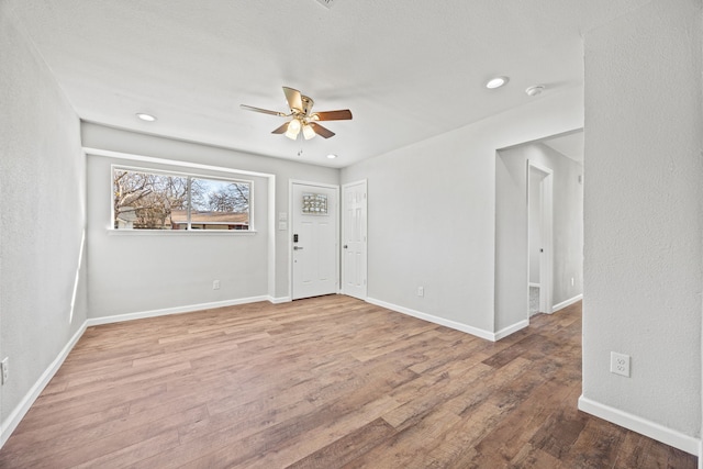 empty room featuring ceiling fan and hardwood / wood-style floors