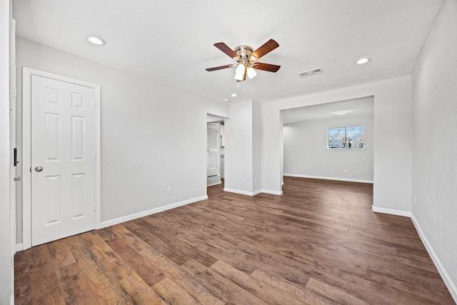 empty room with ceiling fan and dark hardwood / wood-style floors