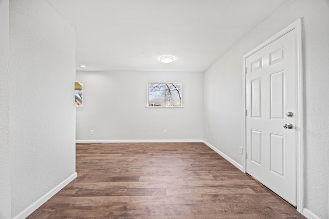 unfurnished room with dark hardwood / wood-style floors