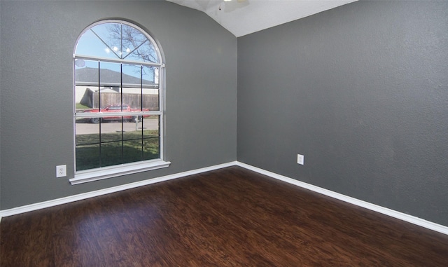 spare room with ceiling fan, lofted ceiling, and hardwood / wood-style flooring