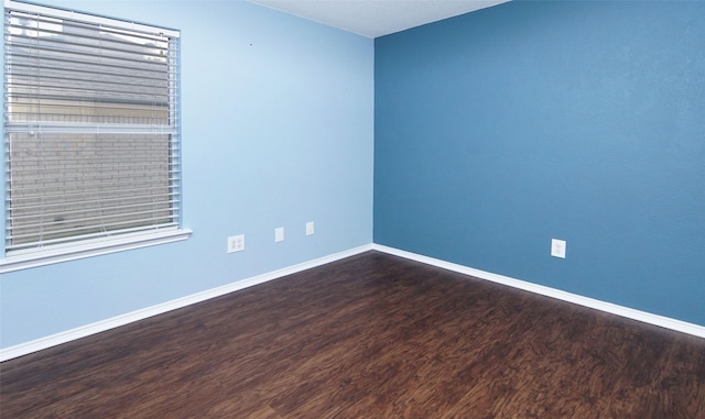 spare room featuring dark hardwood / wood-style floors