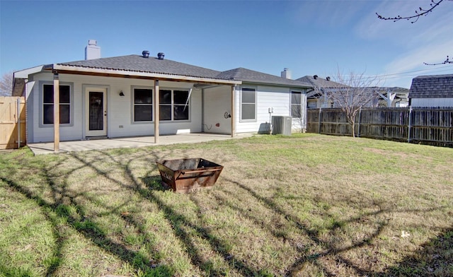 back of property with a lawn, a patio, and central AC unit