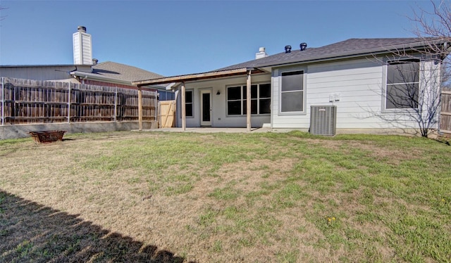 back of property featuring a lawn, central AC unit, and a patio area