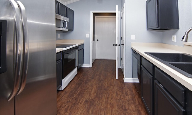 kitchen with stainless steel appliances, dark hardwood / wood-style floors, ornamental molding, and sink