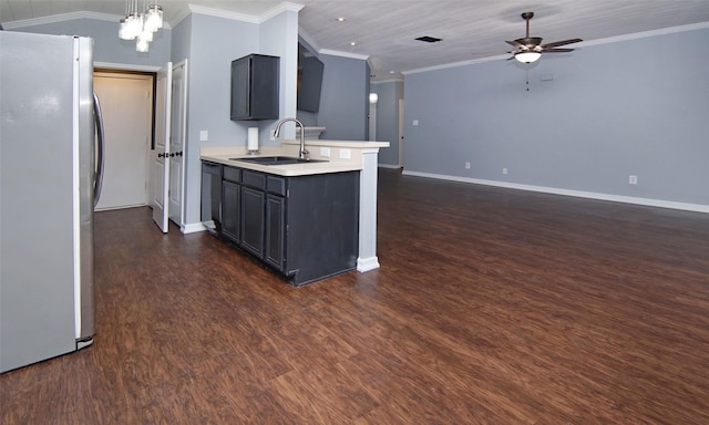 kitchen featuring stainless steel fridge, ceiling fan with notable chandelier, crown molding, sink, and lofted ceiling