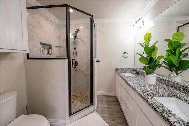 bathroom with toilet, an enclosed shower, ornamental molding, and vanity