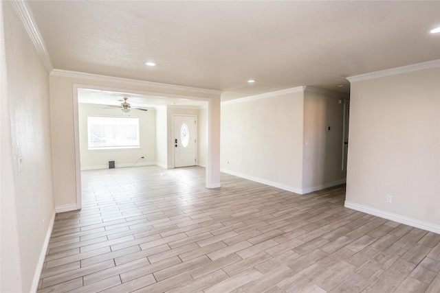 spare room featuring crown molding and ceiling fan