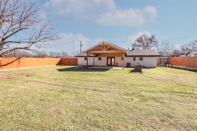 rear view of house featuring a patio area, a yard, and central air condition unit