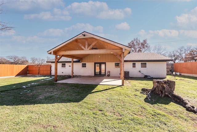 back of house with a lawn, central air condition unit, and a patio