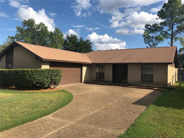 single story home featuring a garage and a front lawn