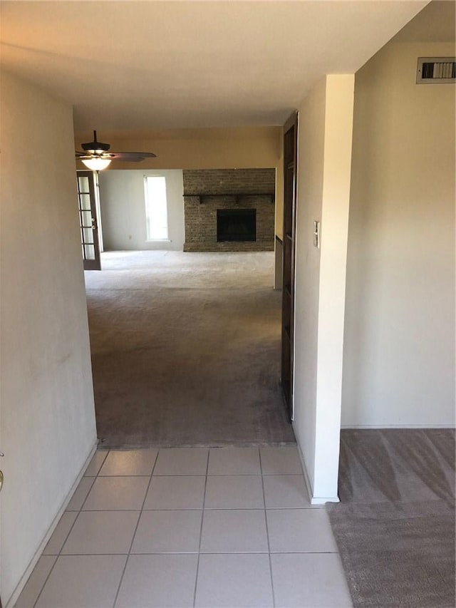 hall featuring light tile patterned flooring