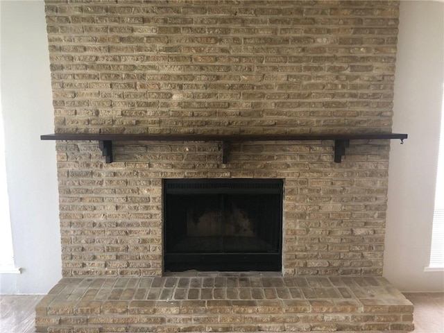 interior details with a brick fireplace