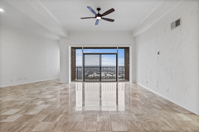 spare room featuring ceiling fan and crown molding