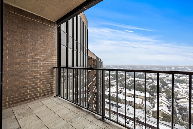 view of snow covered back of property