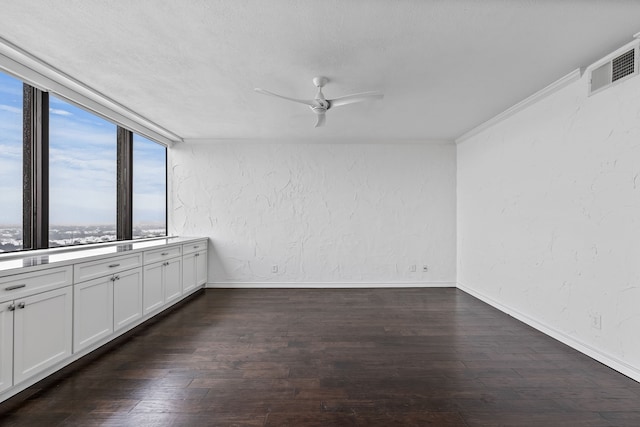 empty room with ceiling fan and dark wood-type flooring