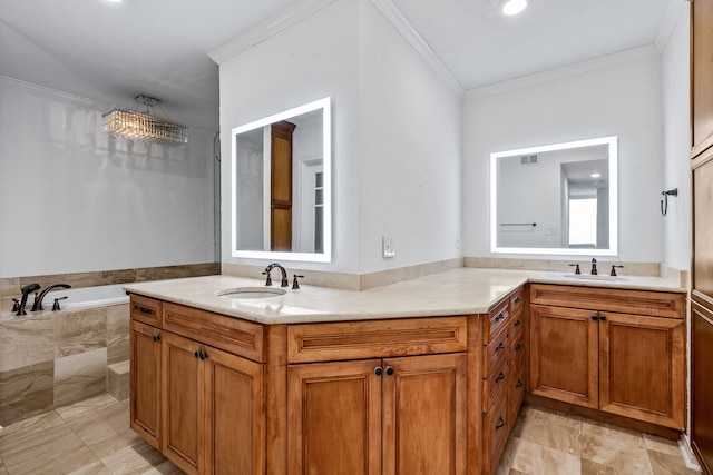 bathroom with tiled bath, crown molding, vanity, and a chandelier