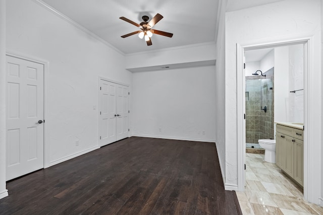 unfurnished bedroom featuring ensuite bathroom, crown molding, ceiling fan, and light hardwood / wood-style flooring