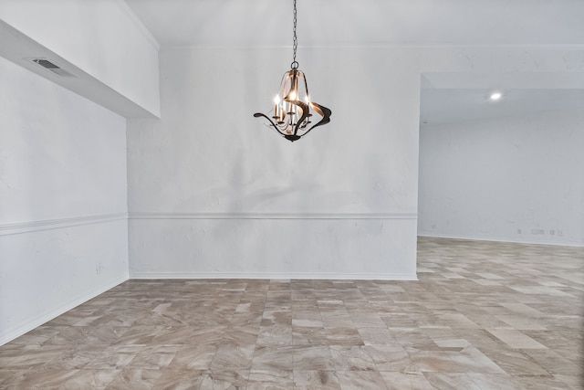 unfurnished room featuring a chandelier