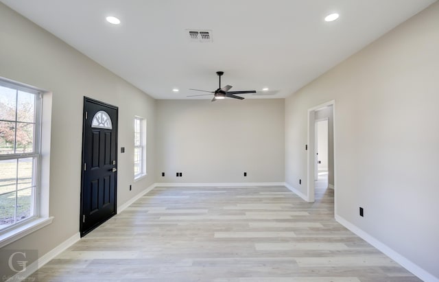 entrance foyer featuring light wood-type flooring, ceiling fan, and a healthy amount of sunlight