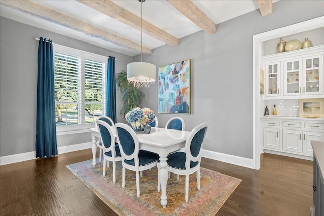 dining area with beam ceiling, dark hardwood / wood-style floors, and an inviting chandelier