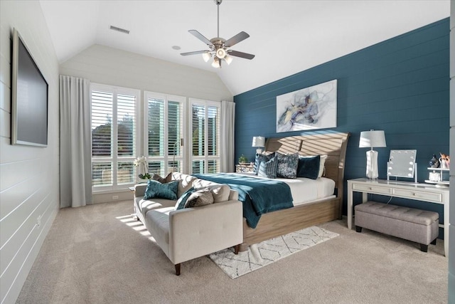 bedroom with ceiling fan, light carpet, and vaulted ceiling