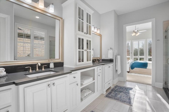 bathroom with ceiling fan, an enclosed shower, and vanity