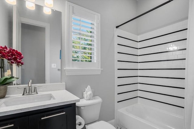 full bathroom with tiled shower / bath combo, toilet, and vanity