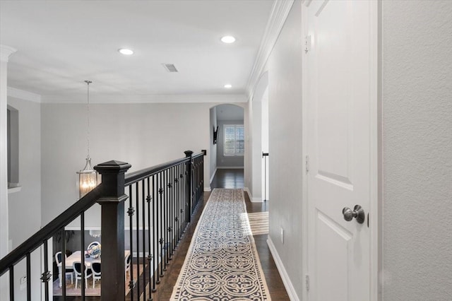 hallway with ornamental molding and dark wood-type flooring