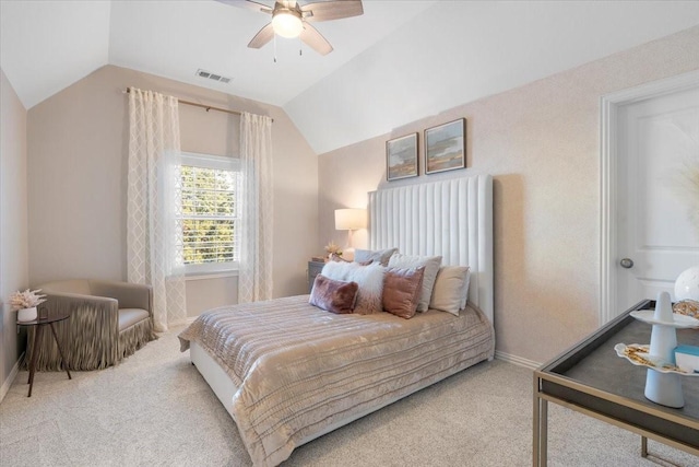 bedroom with ceiling fan, light carpet, and vaulted ceiling