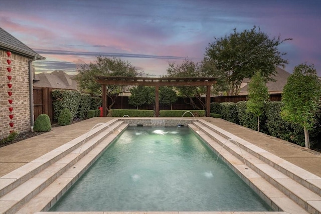 pool at dusk featuring pool water feature