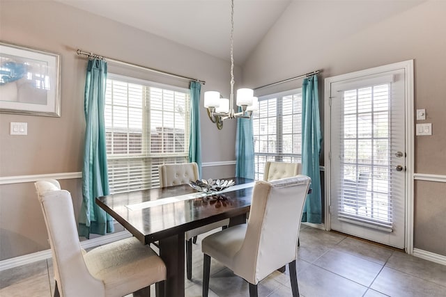 tiled dining space featuring vaulted ceiling and a notable chandelier