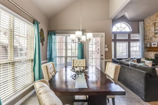 dining space with plenty of natural light, light tile patterned flooring, lofted ceiling, and a notable chandelier