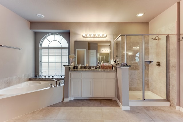 bathroom featuring tile patterned floors, vanity, and plus walk in shower