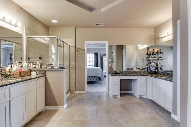 bathroom featuring vanity, tile patterned floors, and a shower with shower door