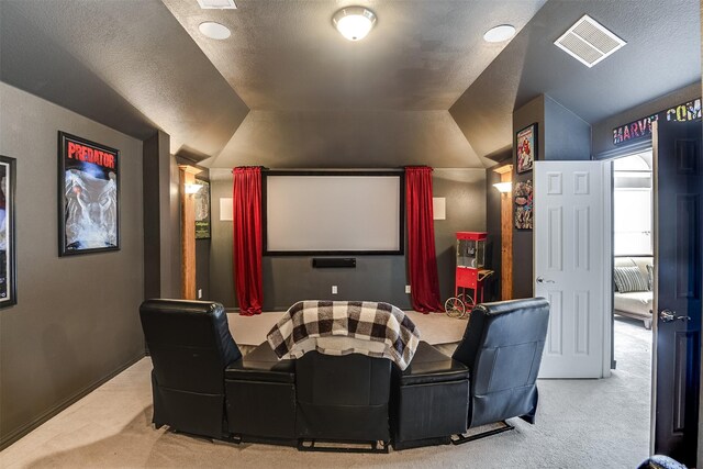 home theater room with carpet flooring, a textured ceiling, and vaulted ceiling