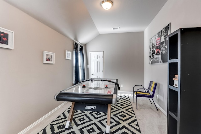 recreation room featuring light colored carpet and lofted ceiling