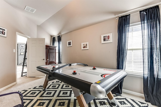 recreation room with light carpet, vaulted ceiling, and a wealth of natural light