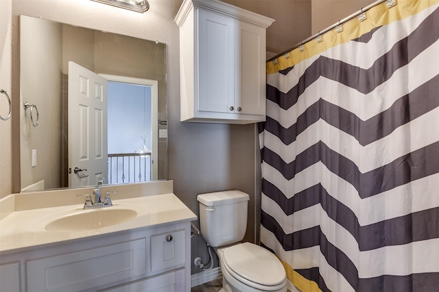 bathroom with vanity, curtained shower, and toilet