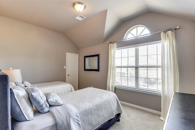 carpeted bedroom featuring vaulted ceiling