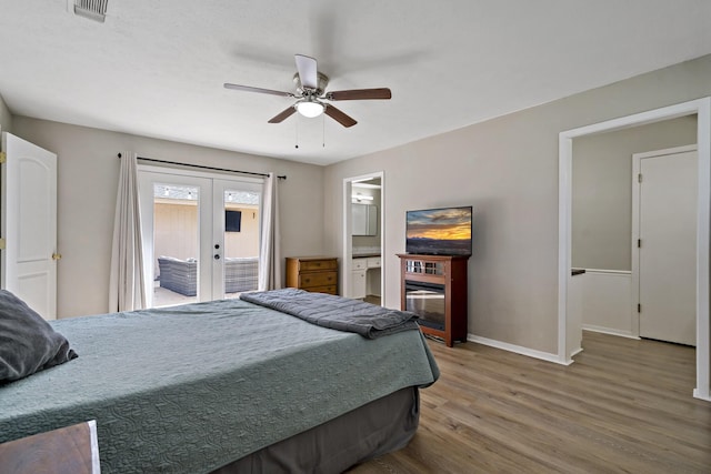 bedroom featuring access to exterior, french doors, ensuite bathroom, ceiling fan, and hardwood / wood-style floors