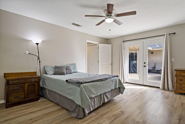 bedroom with access to exterior, french doors, light wood-type flooring, and ceiling fan