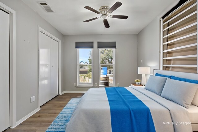 exercise room with ceiling fan and light wood-type flooring