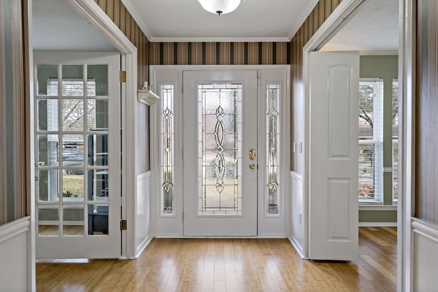 entrance foyer with light hardwood / wood-style floors and ornamental molding